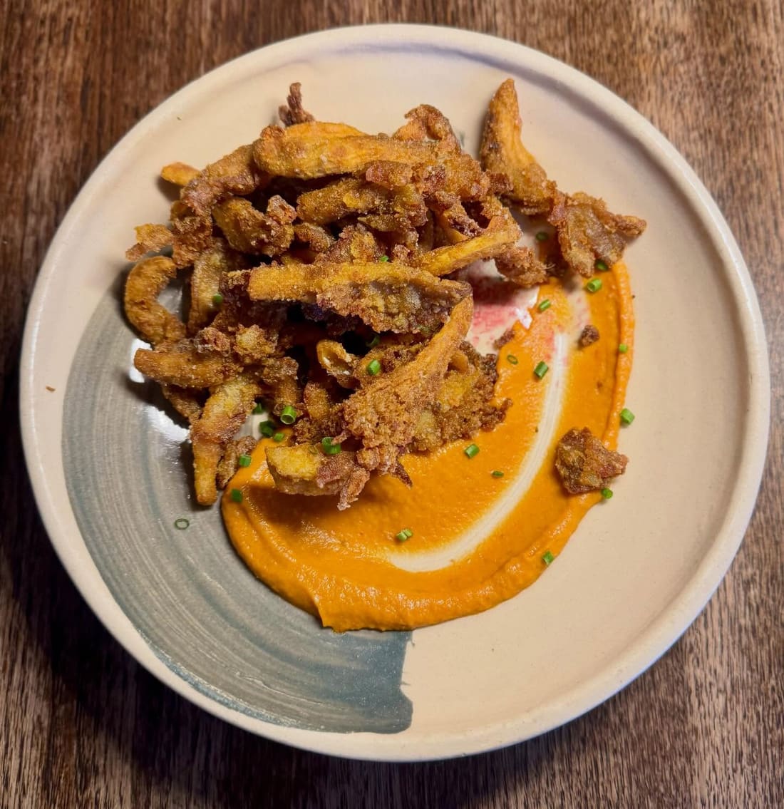 Crisp-fried pieces over a tomato chutney smear