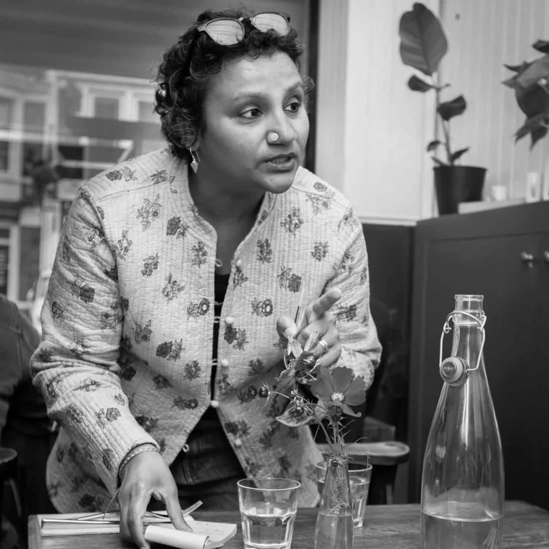 Saritha in conversation during service, in black and white