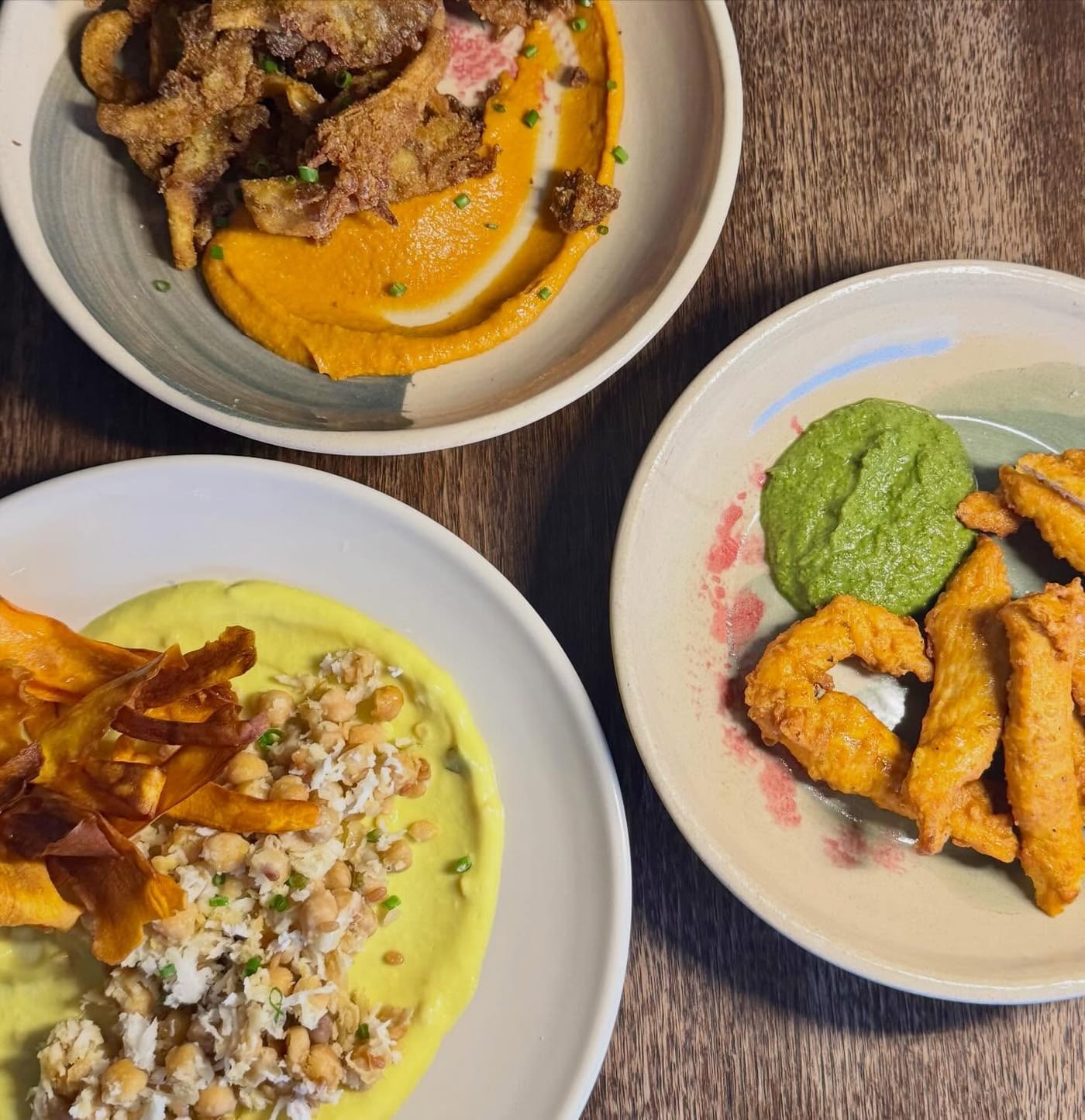 An overhead table spread of shared plates at The Pukka Peacock